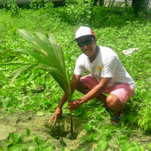 Man working with coconuts